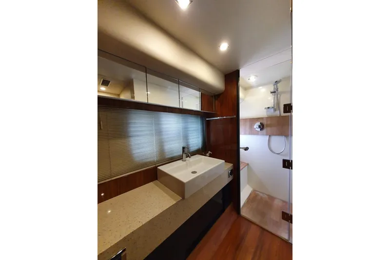 Slide: The Image of Luxurious bathroom in 2010 Fairline Squadron 55 yacht with modern fixtures and wood accents. - 18