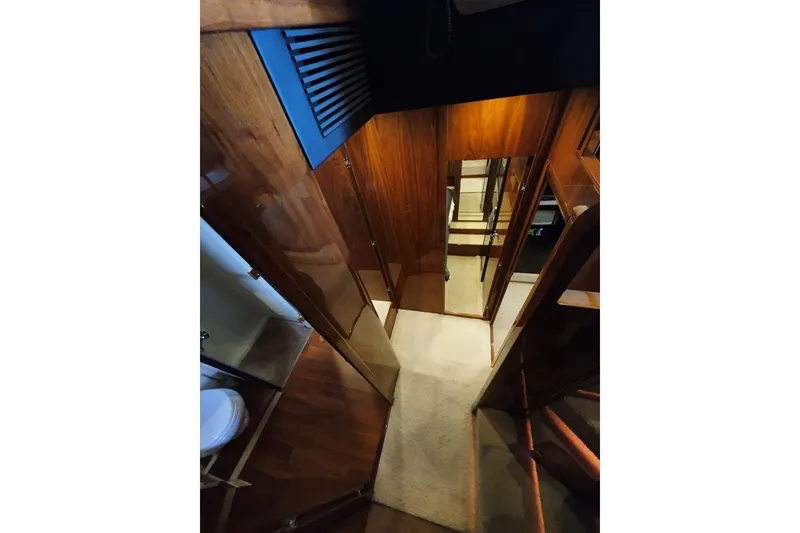 Slide: The Image of Interior hallway of 2010 Fairline Squadron 55 yacht with wooden paneling and carpeted floor. - 21