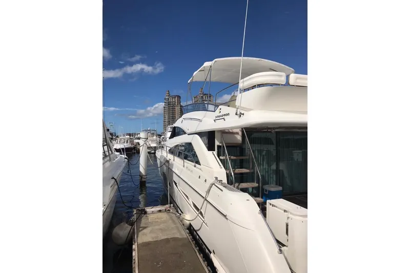 Slide: The Image of 2010 Fairline Squadron 55 yacht docked at marina under clear blue sky. - 4
