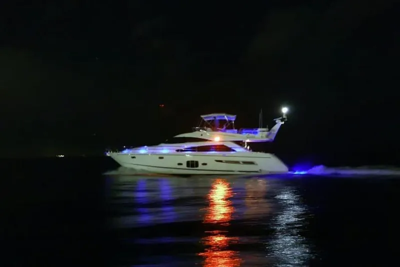 Slide: The Image of 2010 Fairline Squadron 55 yacht illuminated at night on calm water. - 9