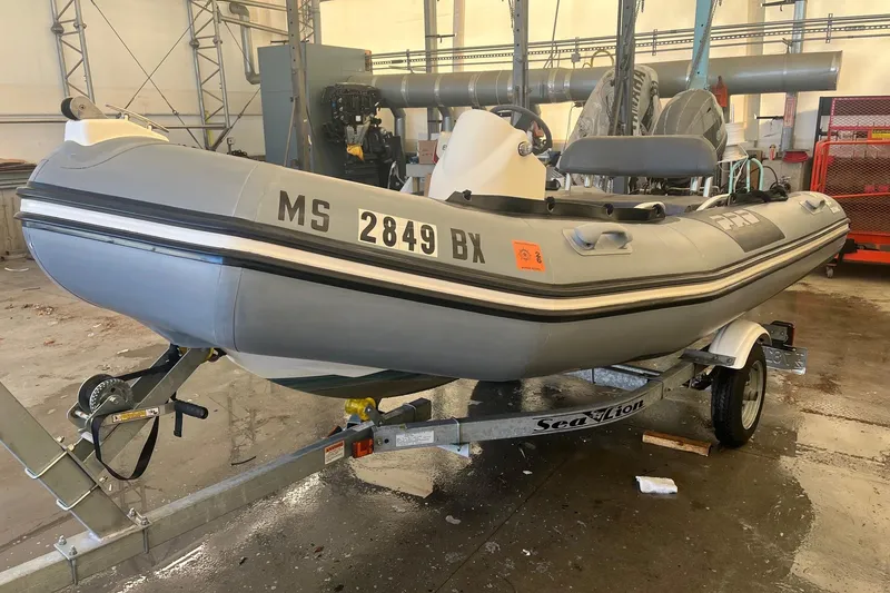 Slide: The Image of 2010 Zodiac Bayrunner 420 inflatable boat on trailer in a garage setting. - 2