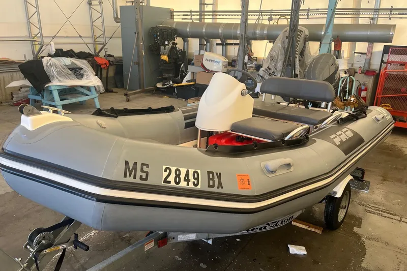 Slide: The Image of 2010 Zodiac Bayrunner 420 inflatable boat on trailer in a workshop setting. - 3