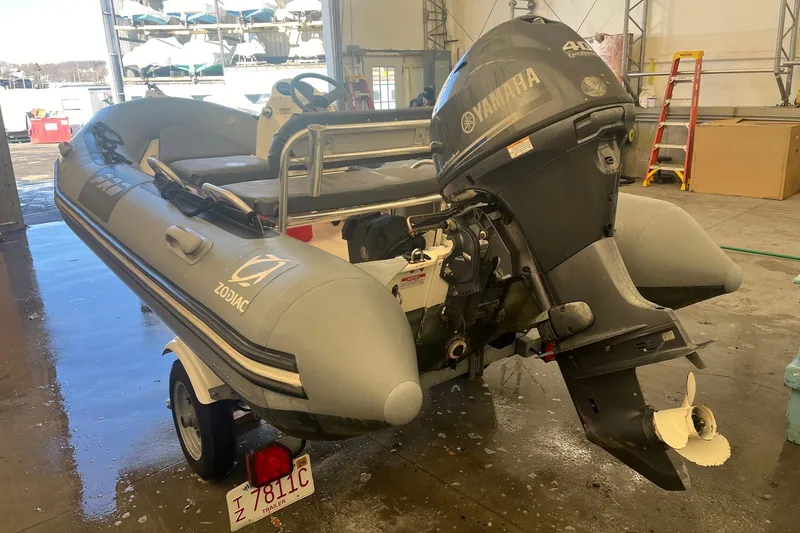 Slide: The Image of 2010 Zodiac Bayrunner 420 inflatable boat with Yamaha outboard motor in a garage setting. - 4
