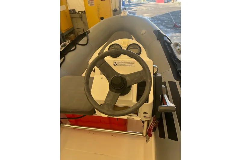 Slide: The Image of Steering console of a 2010 Zodiac Bayrunner 420 inflatable boat in a workshop setting. - 6