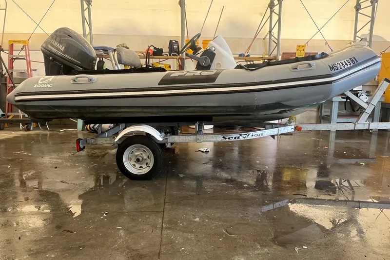 Slide: The Image of 2010 Zodiac Bayrunner 420 inflatable boat on trailer in a garage setting. - 7