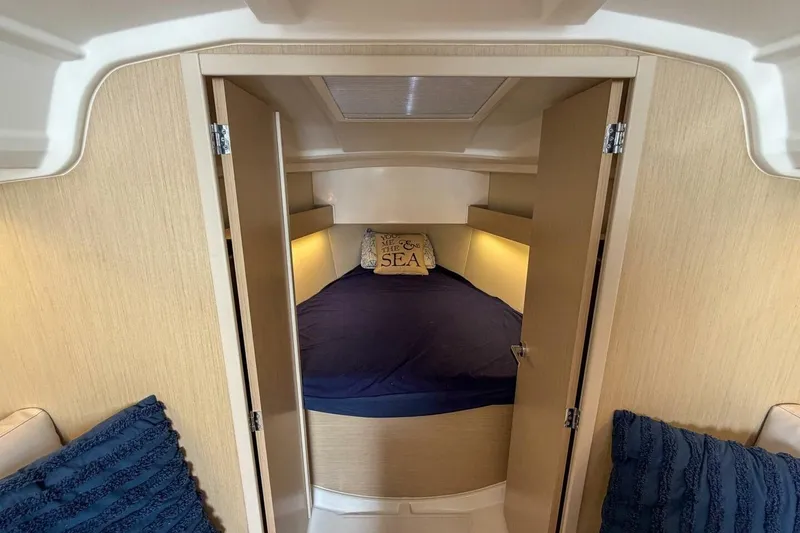 Slide: The Image of Cozy cabin interior of 2021 Beneteau Oceanis 30.1 sailboat with nautical decor. - 14