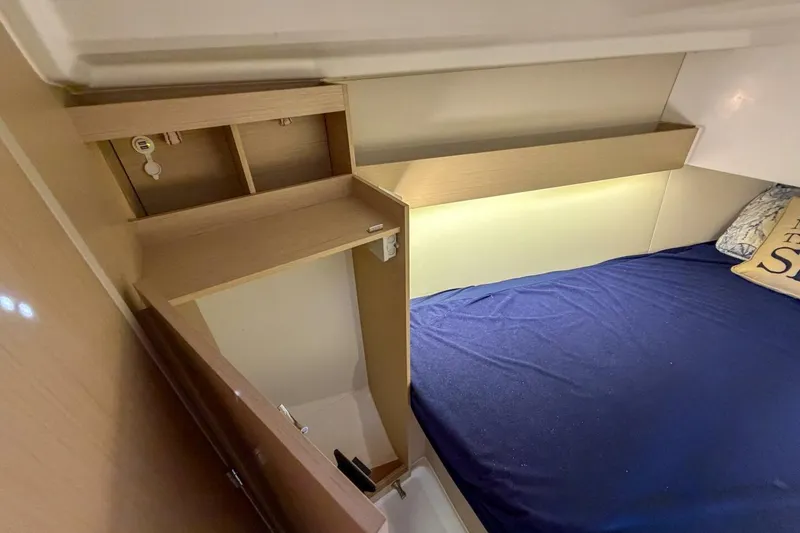 Slide: The Image of Interior cabin of 2021 Beneteau Oceanis 30.1 yacht with cozy bed and wooden storage. - 16