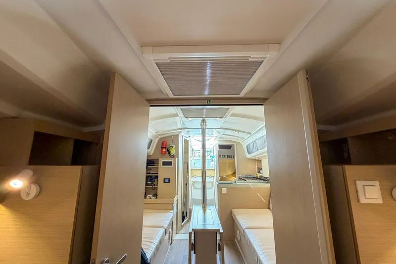 Slide: The Image of Interior of 2021 Beneteau Oceanis 30.1 yacht, featuring cozy cabin and modern amenities. - 18