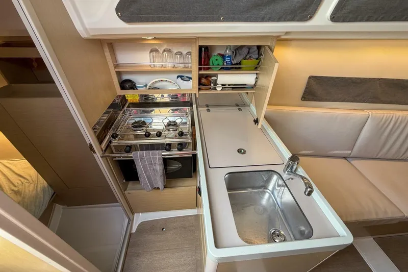 Slide: The Image of Interior of 2021 Beneteau Oceanis 30.1 yacht kitchen with stove and sink. - 19