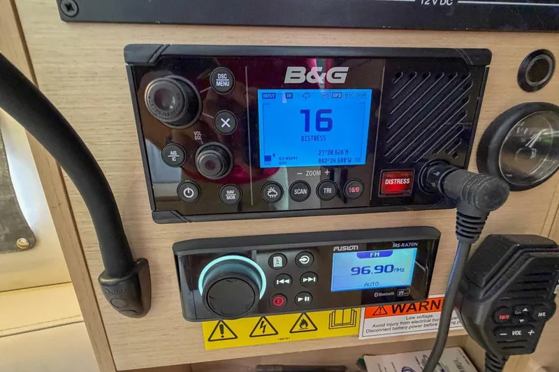 Slide: The Image of Control panel of a 2021 Beneteau Oceanis 30.1 sailboat with radio and navigation systems. - 24