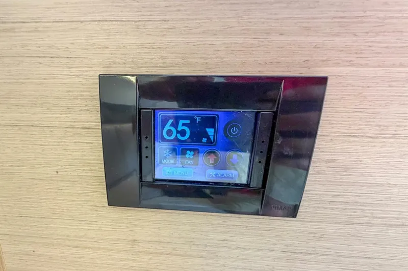Slide: The Image of Digital thermostat display on 2021 Beneteau Oceanis 30.1 yacht, showing 65°F. - 25