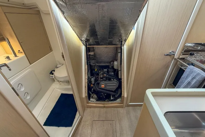 Slide: The Image of Engine compartment of a 2021 Beneteau Oceanis 30.1 yacht, adjacent to bathroom and kitchen. - 26
