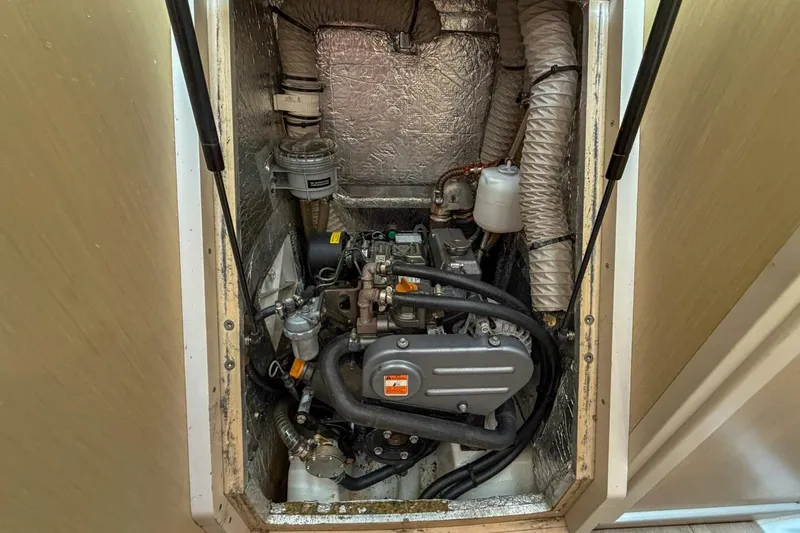 Slide: The Image of Engine compartment of a 2021 Beneteau Oceanis 30.1 sailboat, showcasing mechanical components. - 27