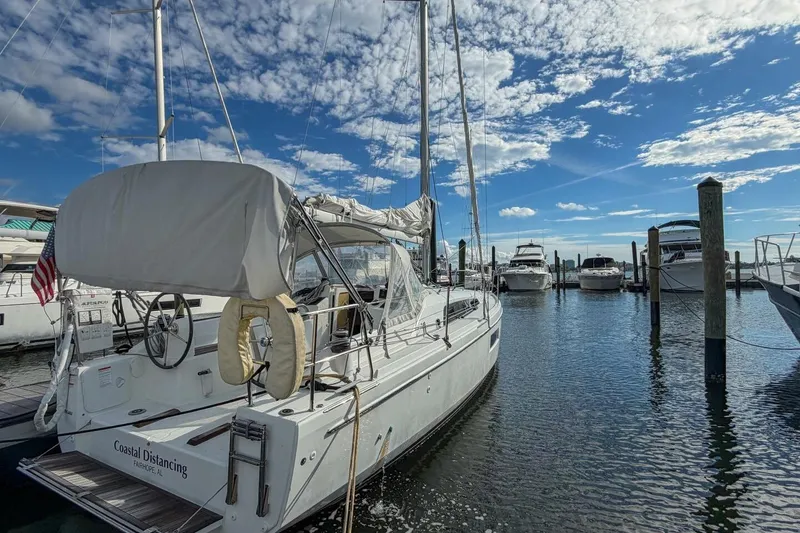 Slide: The Image of 2021 Beneteau Oceanis 30.1 sailboat docked at marina under blue sky. - 39