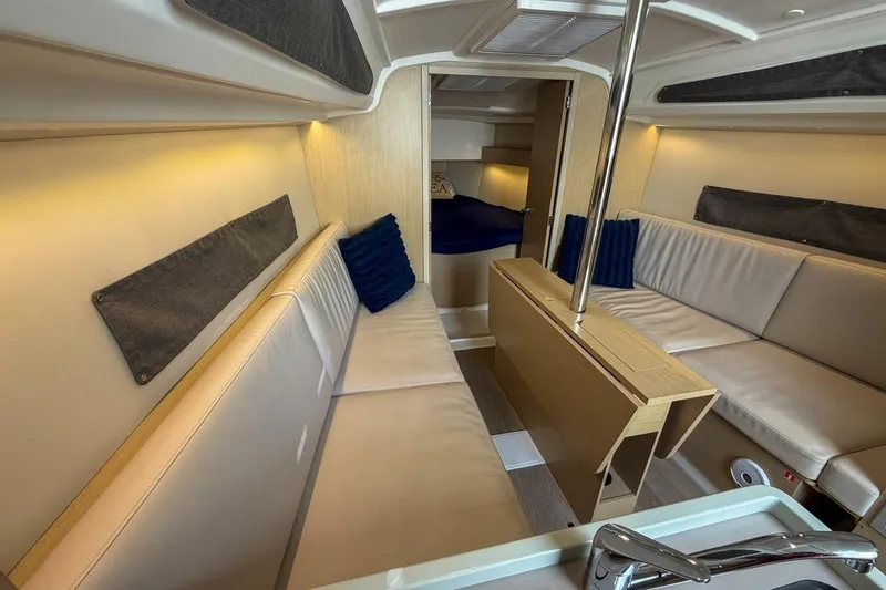 Slide: The Image of Interior of 2021 Beneteau Oceanis 30.1 yacht, featuring cozy seating and modern design. - 4