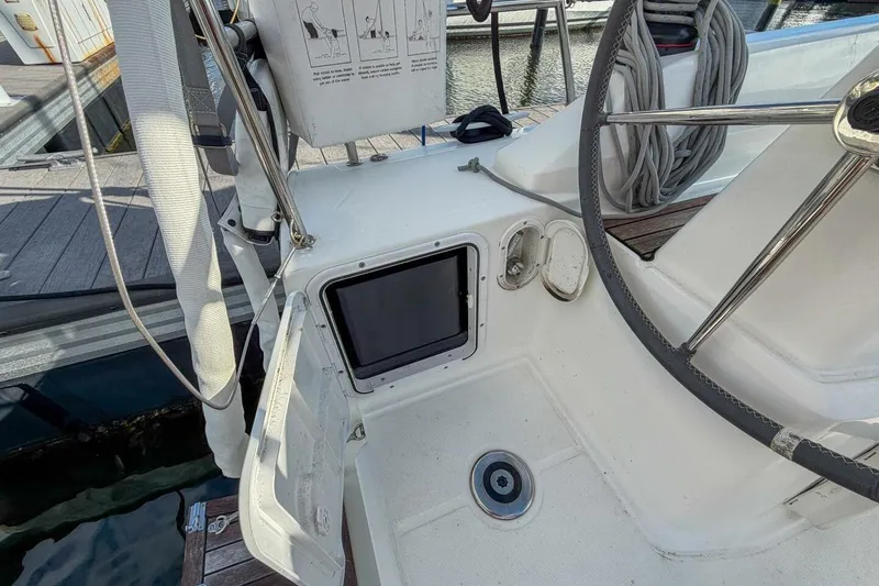 Slide: The Image of Cockpit of 2021 Beneteau Oceanis 30.1 sailboat with steering wheel and control panel. - 43
