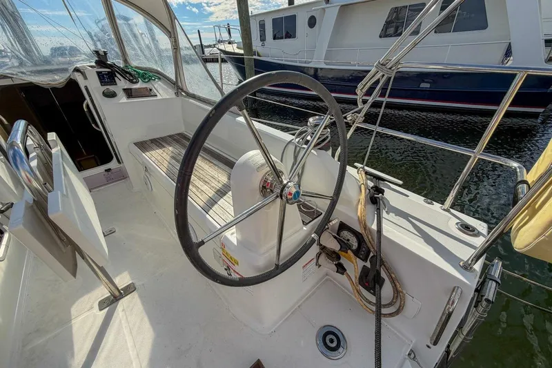 Slide: The Image of Cockpit of 2021 Beneteau Oceanis 30.1 sailboat with steering wheel and seating. - 44