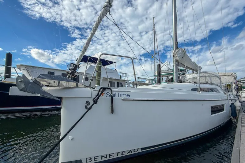 Slide: The Image of 2021 Beneteau Oceanis 30.1 sailboat docked under a partly cloudy sky. - 54