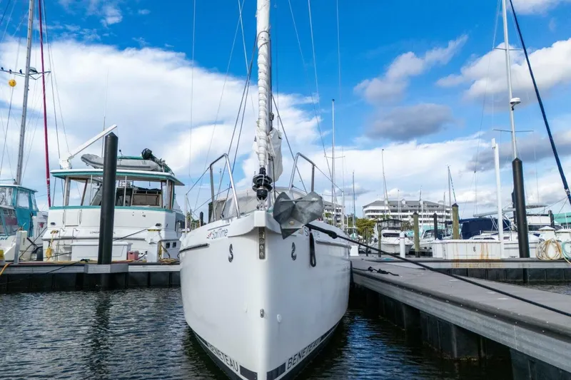 Slide: The Image of 2021 Beneteau Oceanis 30.1 sailboat docked at marina under blue sky. - 60
