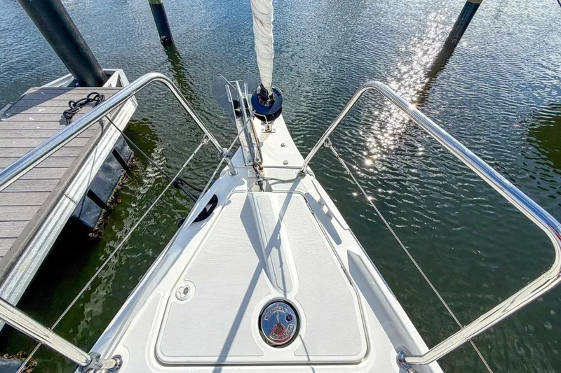 Slide: The Image of Bow of 2021 Beneteau Oceanis 30.1 sailboat docked on calm water. - 73