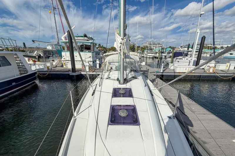 Slide: The Image of 2021 Beneteau Oceanis 30.1 sailboat docked in a marina under a blue sky. - 76