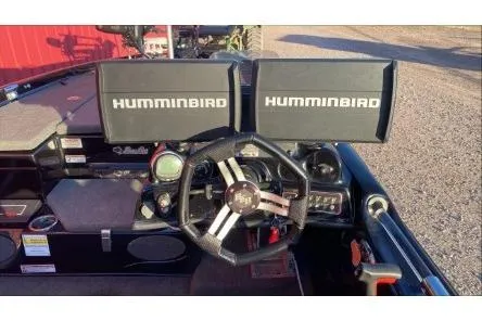 Slide: The Image of 2020 Bass Cat Eyra Premium dashboard with dual Humminbird displays and steering wheel. - 3