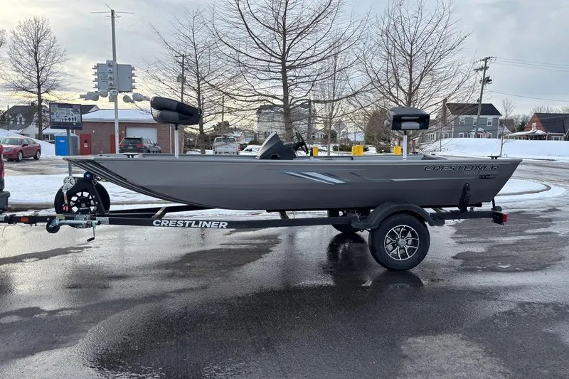 The Image of 2026 Crestliner 1600 Storm boat on trailer in snowy urban setting. - 0