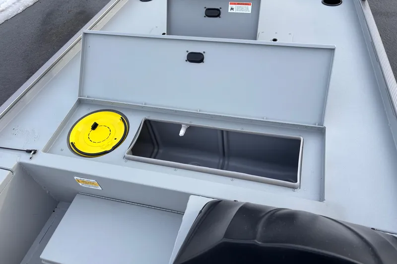 Slide: The Image of 2026 Crestliner 1600 Storm boat interior with storage compartments and yellow hatch. - 4