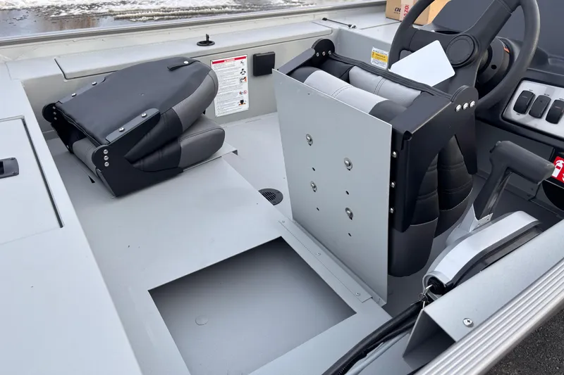 Slide: The Image of 2026 Crestliner 1600 Storm boat interior with folded seats and steering wheel. - 5