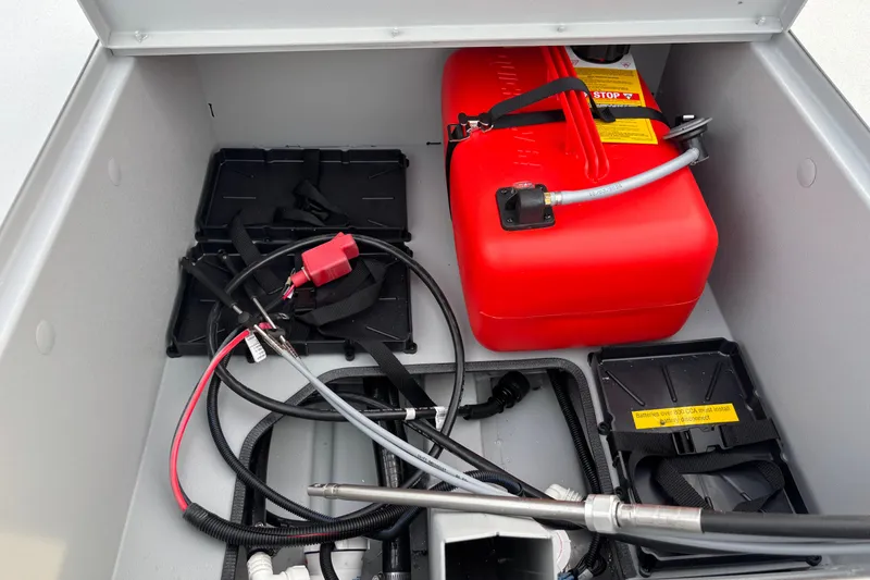 Slide: The Image of 2026 Crestliner 1600 Storm boat storage with red fuel tank and wiring components. - 8