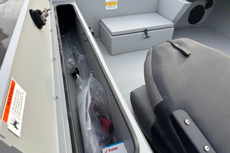 Slide: The Image of 2026 Crestliner 1600 Storm boat interior with storage compartment and seating. - 9