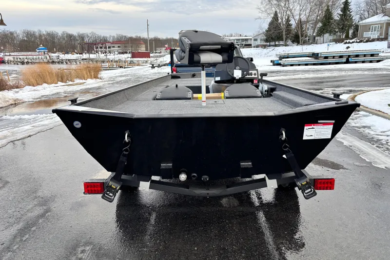 Slide: The Image of 2026 Crestliner 1700 Storm boat on a snowy dock, rear view. - 10