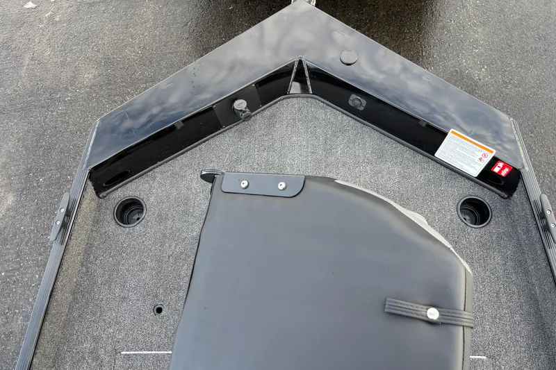 Slide: The Image of 2026 Crestliner 1700 Storm boat deck with storage compartment and carpeted surface. - 7