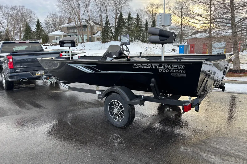 Slide: The Image of 2026 Crestliner 1700 Storm boat on trailer, parked on wet road in winter setting. - 9