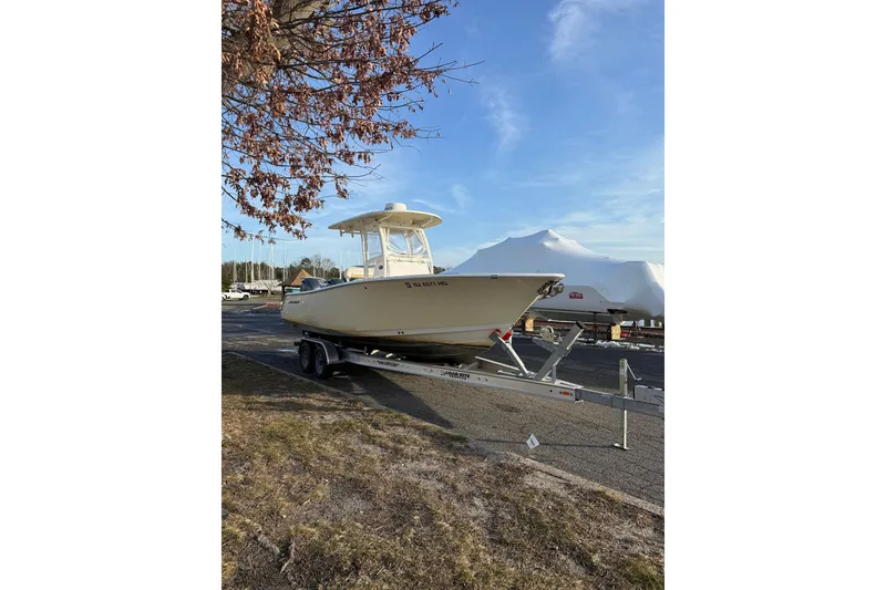 Slide: The Image of 2015 Sportsman Heritage 251 Center Console boat on trailer, parked outdoors. - 3
