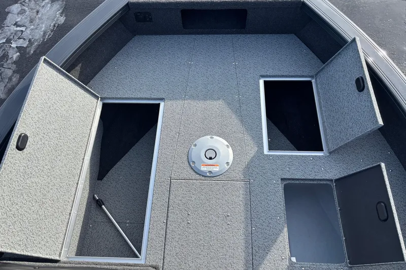 Slide: The Image of 2026 Crestliner 1850 Fish Hawk WT JS boat deck with open storage compartments. - 10