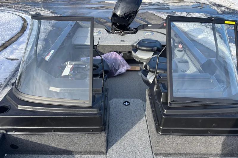 Slide: The Image of 2026 Crestliner 1850 Fish Hawk WT JS boat interior with dual windshields, snowy background. - 11