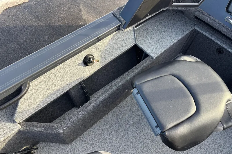 Slide: The Image of 2026 Crestliner 1850 Fish Hawk WT JS interior with seating and storage compartments. - 5