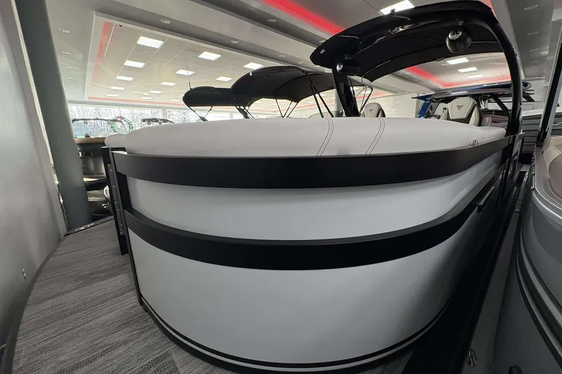 Slide: The Image of 2026 Viaggio D24U A-T pontoon boat in showroom, sleek design, modern interior. - 16