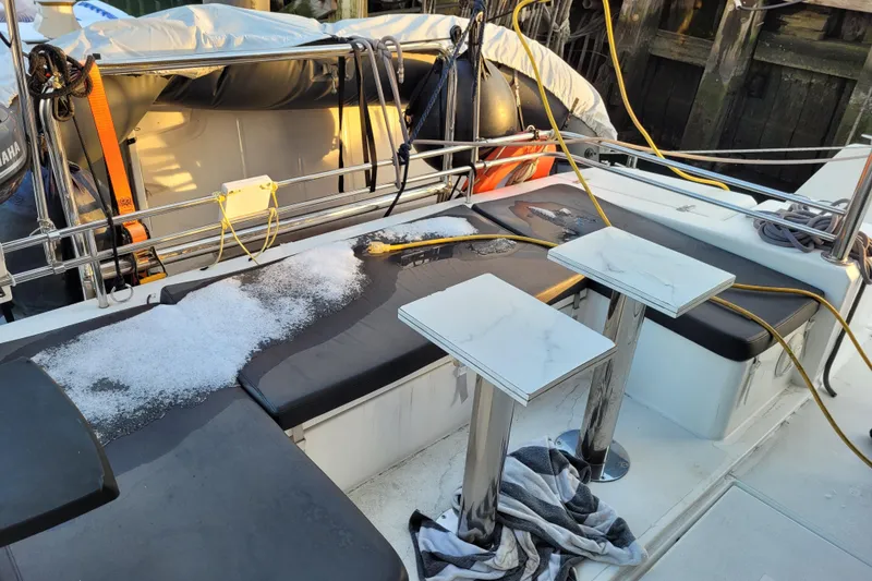 Slide: The Image of Bali 4.3 catamaran deck with snow, tables, and equipment, 2019 model. - 11