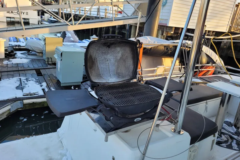 Slide: The Image of Open grill on a 2019 Bali 4.3 catamaran docked in a snowy marina. - 14