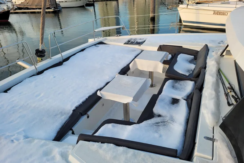 Slide: The Image of Snow-covered deck of a 2019 Bali 4.3 catamaran in a marina. - 18