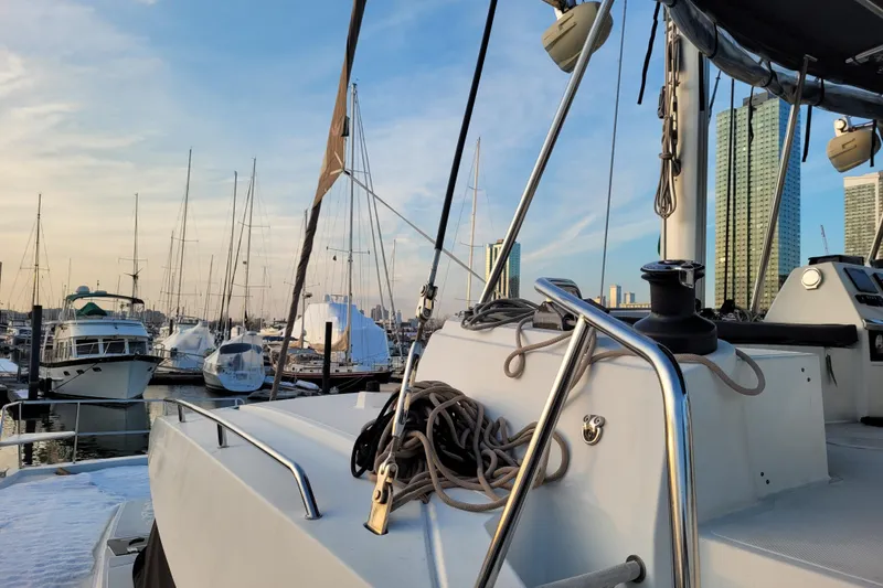 Slide: The Image of 2019 Bali 4.3 catamaran docked in marina with city skyline background. - 23