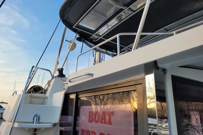 Slide: The Image of 2019 Bali 4.3 catamaran with "Boat for Sale" sign at sunset. - 25