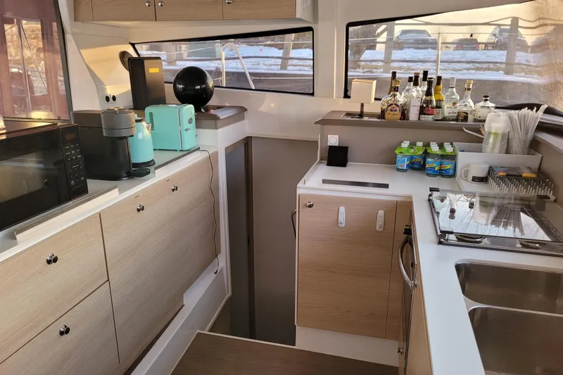 Slide: The Image of Modern kitchen interior on a 2019 Bali 4.3 yacht with appliances and beverages. - 30