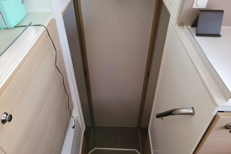 Slide: The Image of Narrow interior passageway on a 2019 Bali 4.3 catamaran, featuring modern cabinetry. - 31