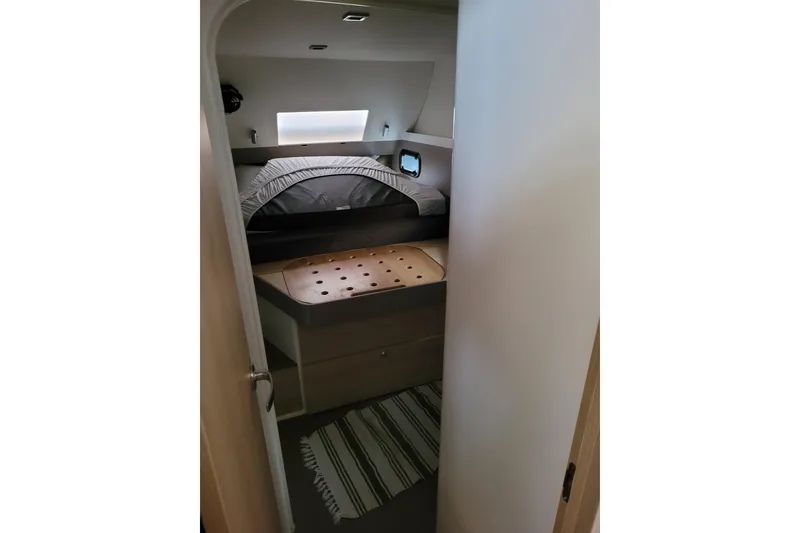 Slide: The Image of Cozy cabin interior of 2019 Bali 4.3 catamaran with bed and striped rug. - 32