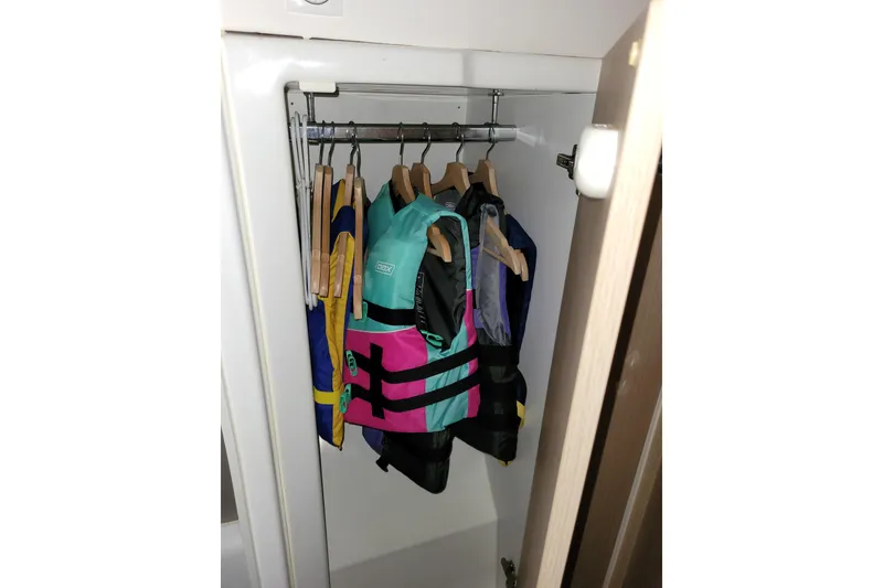 Slide: The Image of Life jackets hanging in a closet on a Bali 4.3, 2019 model. - 34