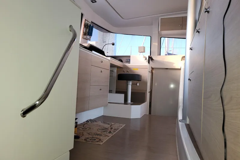 Slide: The Image of Interior of a 2019 Bali 4.3 catamaran, featuring modern cabinetry and seating. - 45