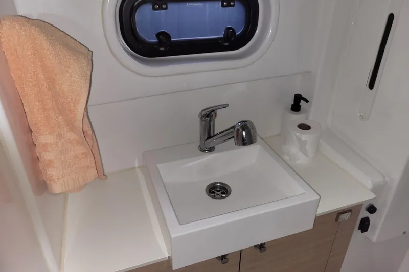 Slide: The Image of Compact bathroom sink in a 2019 Bali 4.3 yacht, featuring a towel and toiletries. - 46